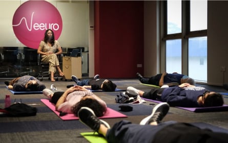 Meditating while laying down on a yoga mat