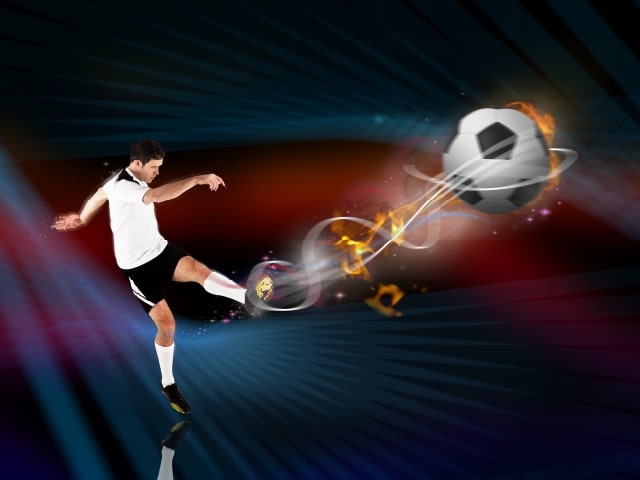 athlete kicking a soccer ball