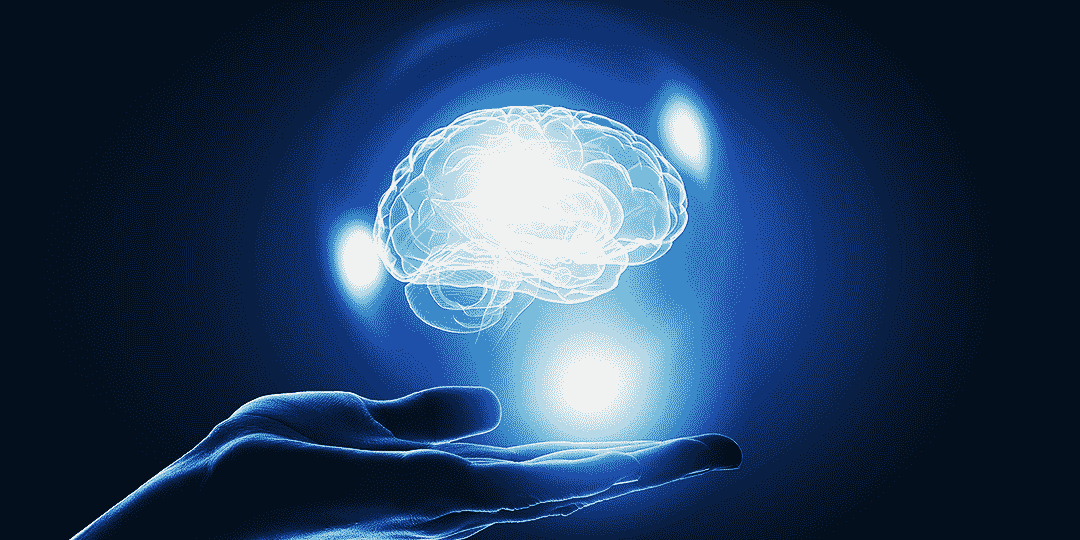 Glowing brain hovering on a person's palm