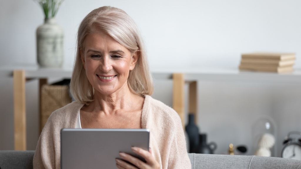 Elderly woman holding a tablet