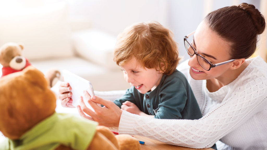 Mother showing mobile device to her kid