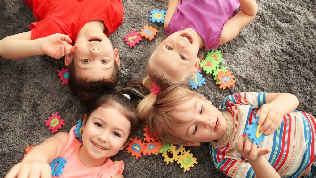 children laying down on the carpet