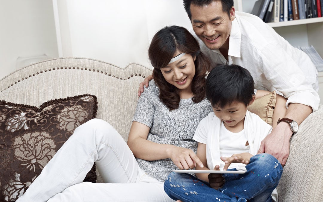 Family navigating tablet device with mother wearing  SenzeBand