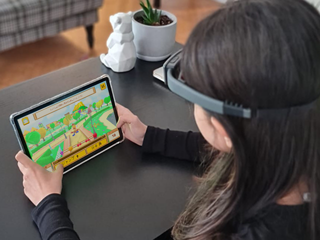 child wearing Neeuro SenzeBand EEG headband while playing cogo